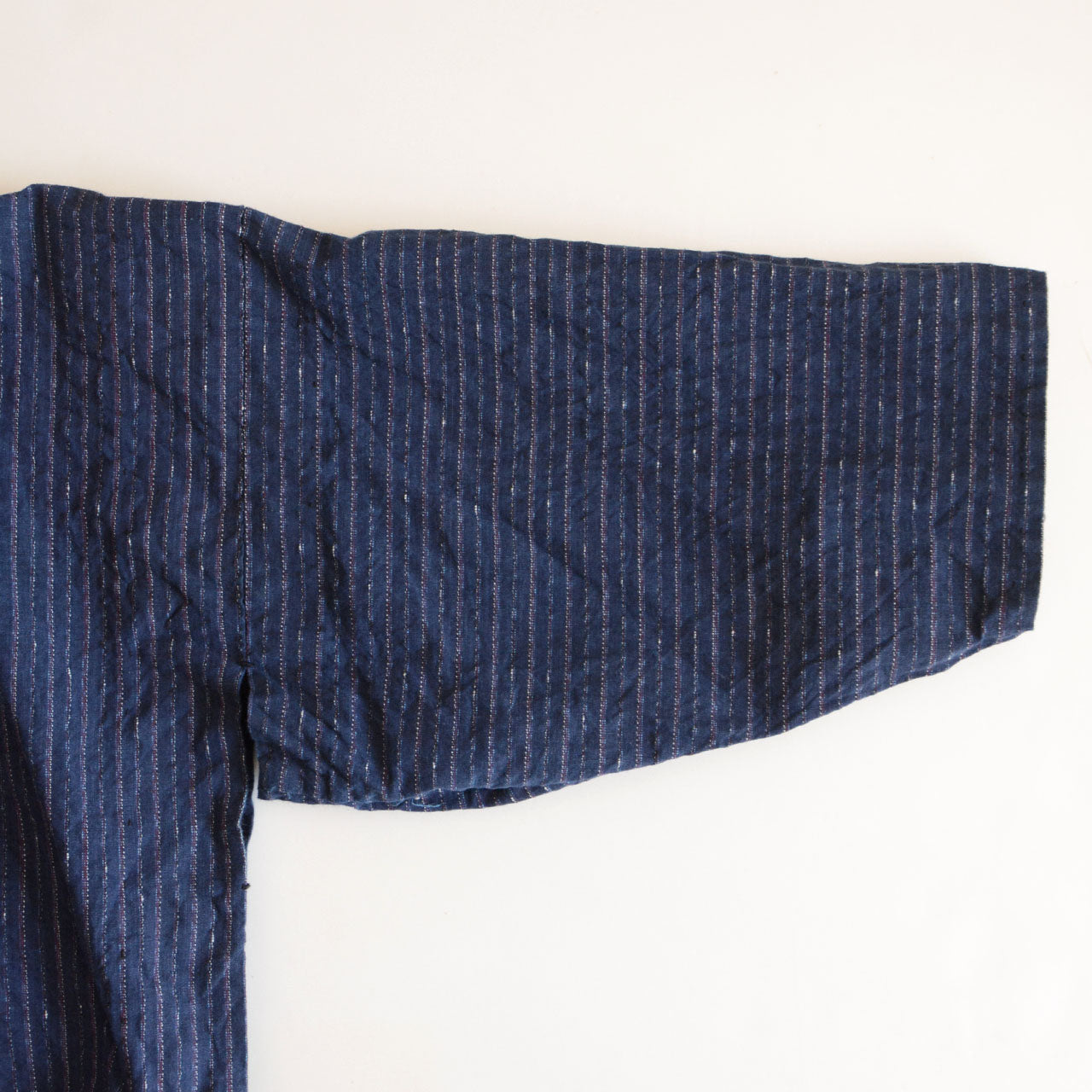 Handcrafted Japanese short-length jacket with lived-in texture.
