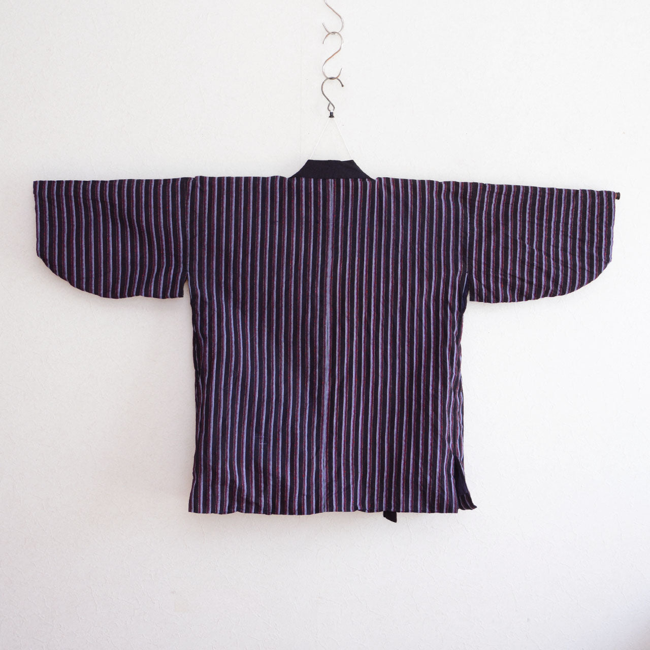 Showa era Japanese boro textile garment crafted from striped cotton fabric