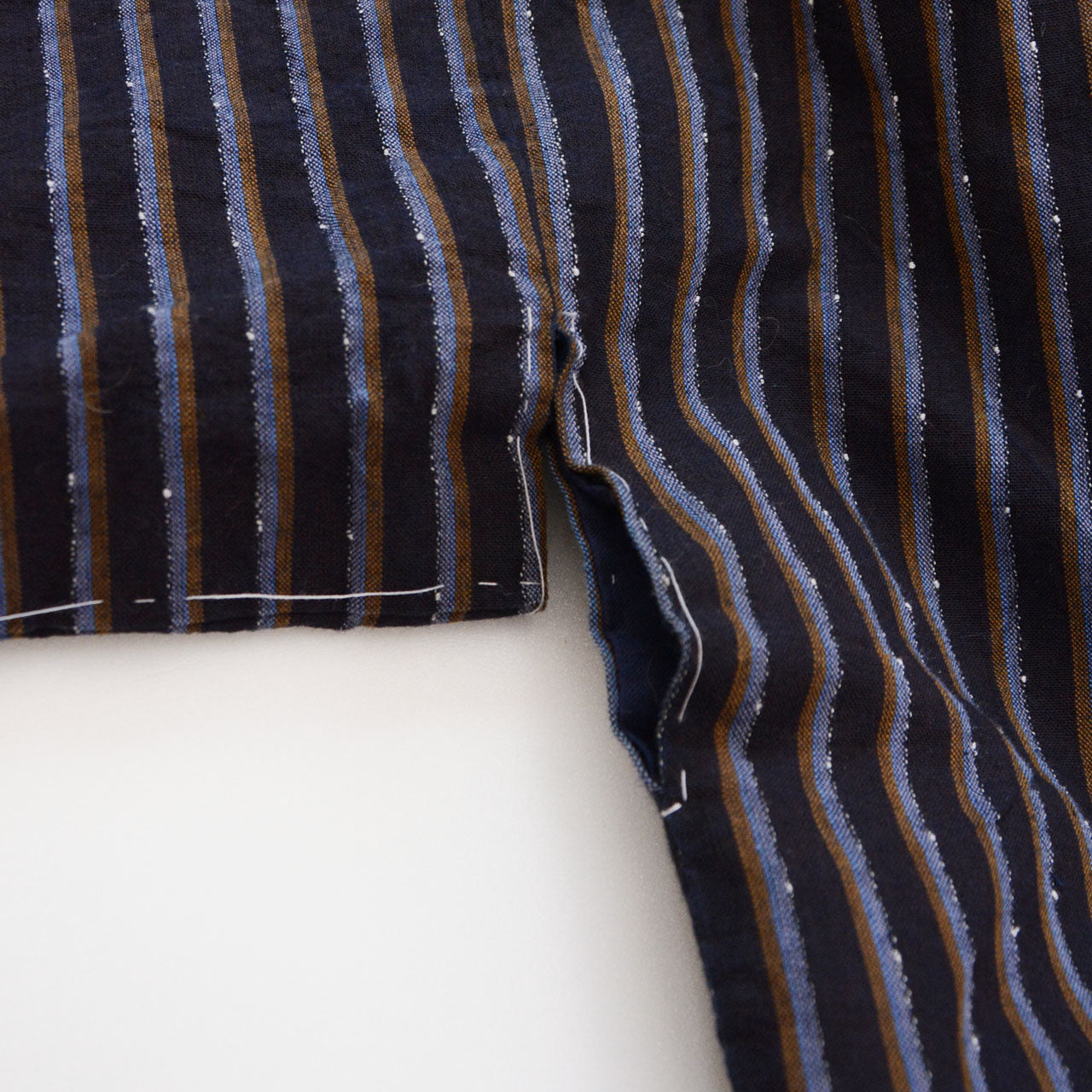Hand-stitched seam detail, vintage Japanese cotton noragi, Showa era workwear, navy stripe