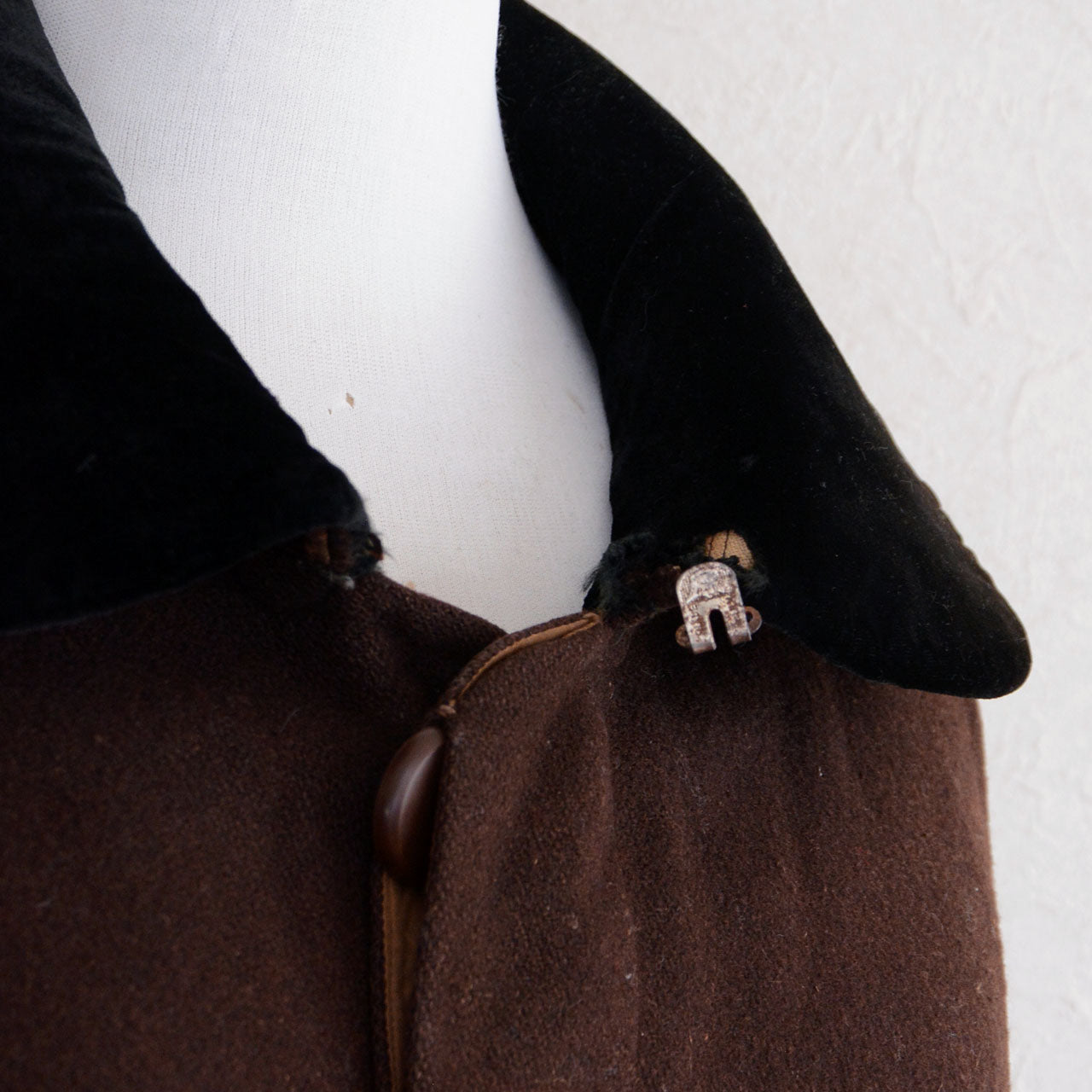 Beige lining and repaired hanging loop of Japanese vintage mantle