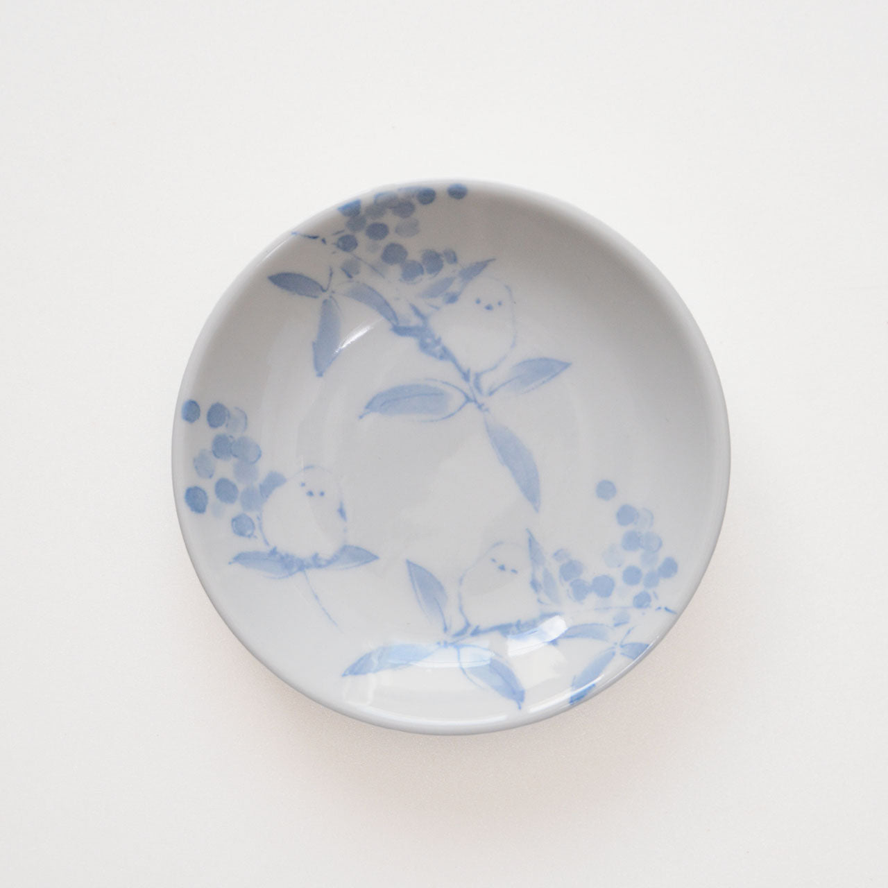 Small indigo-style ceramic plate with bird motif