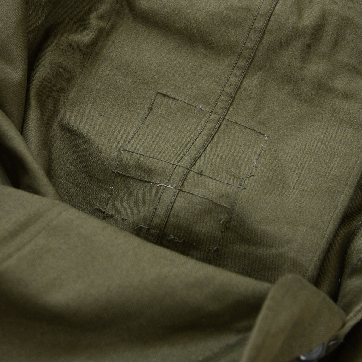 Interior of JGSDF Type 65 work trousers showing the area where the inner tag was removed