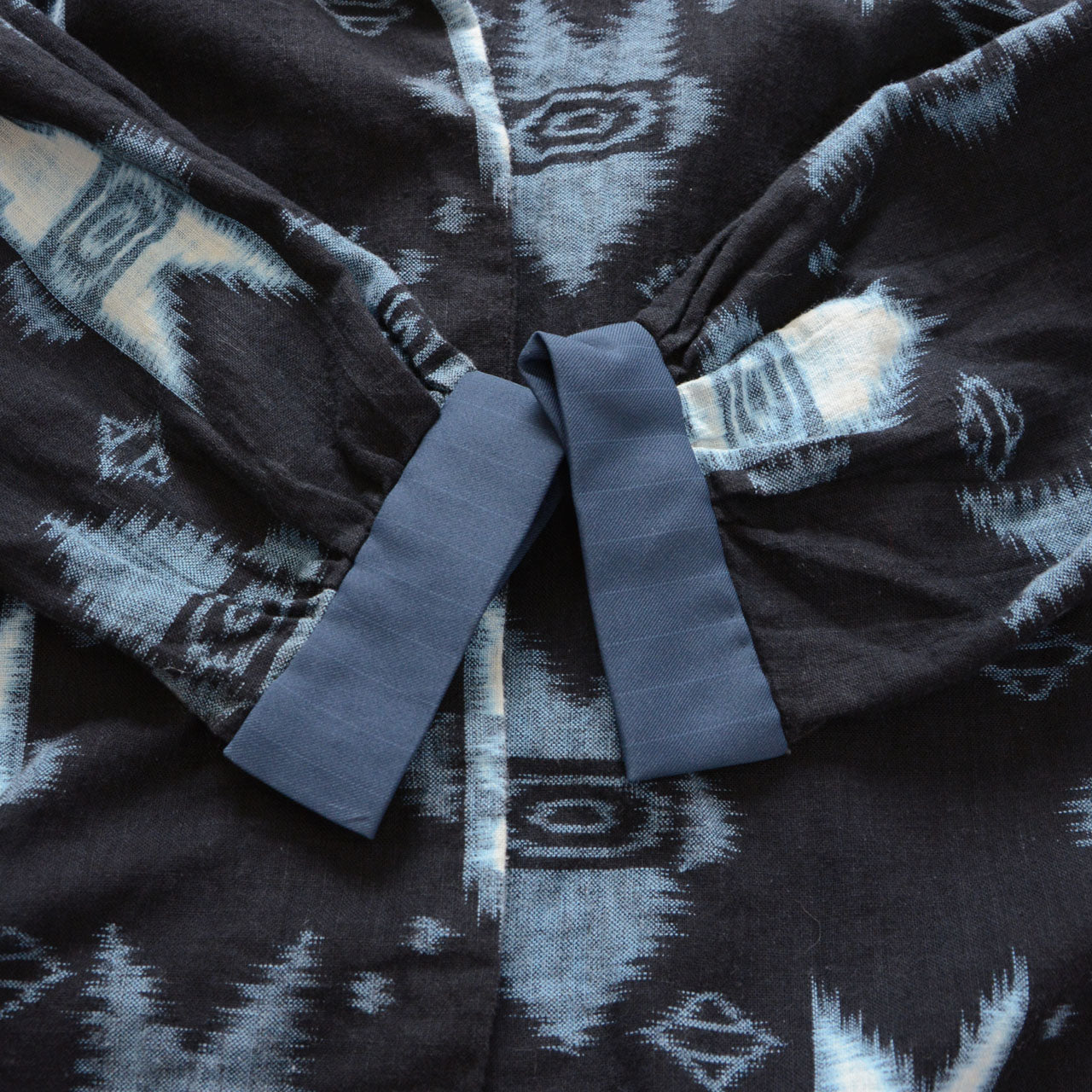 Cuff detail of kasuri ikat cotton shirt — synthetic fabric cuff, handmade Japan vintage mid-Showa