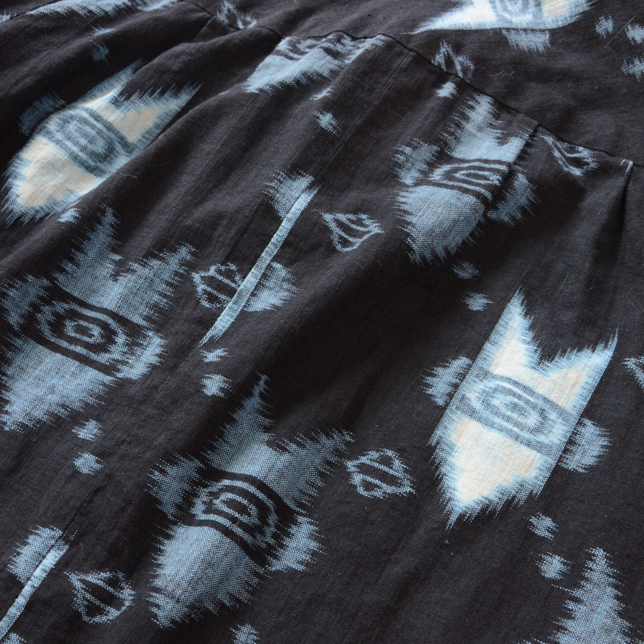 Kasuri ikat textile detail — geometric arrow and diamond pattern, cotton weave, handmade Japan vintage mid-Showa