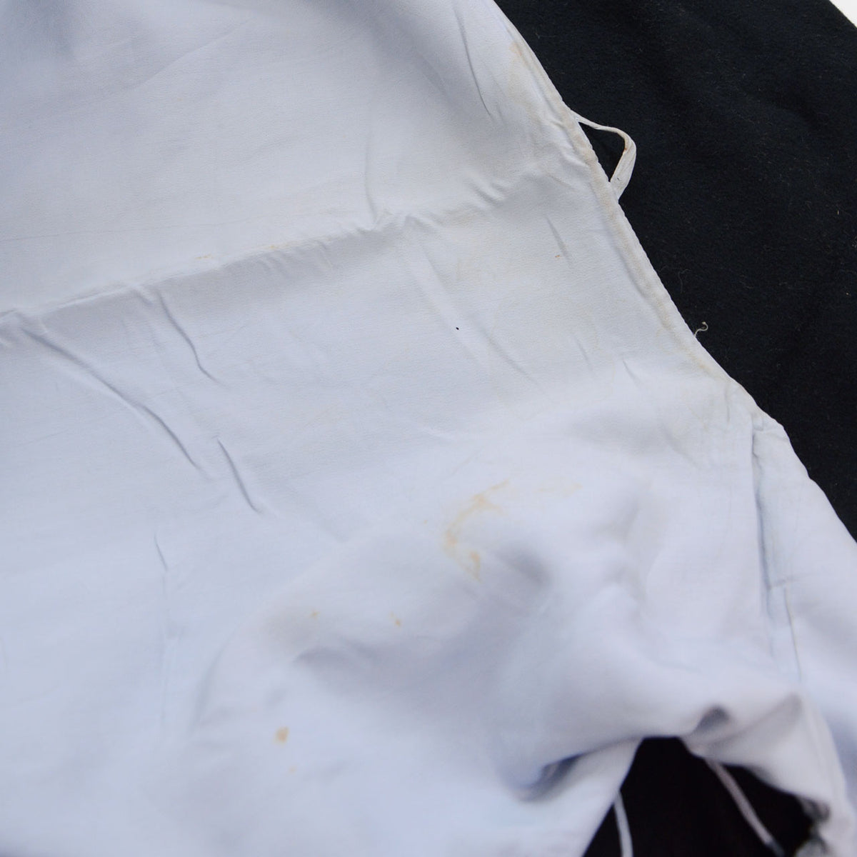 Pale lining with stains in a black wool Japanese vintage kimono coat