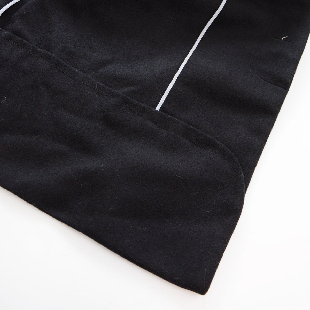 Hand-stitched shortened hem of a black wool Japanese vintage kimono coat