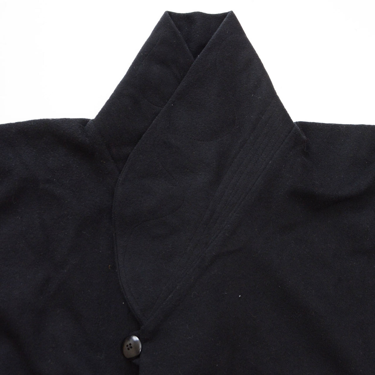 Under-collar stitching on a black wool Japanese vintage kimono coat with a shawl collar