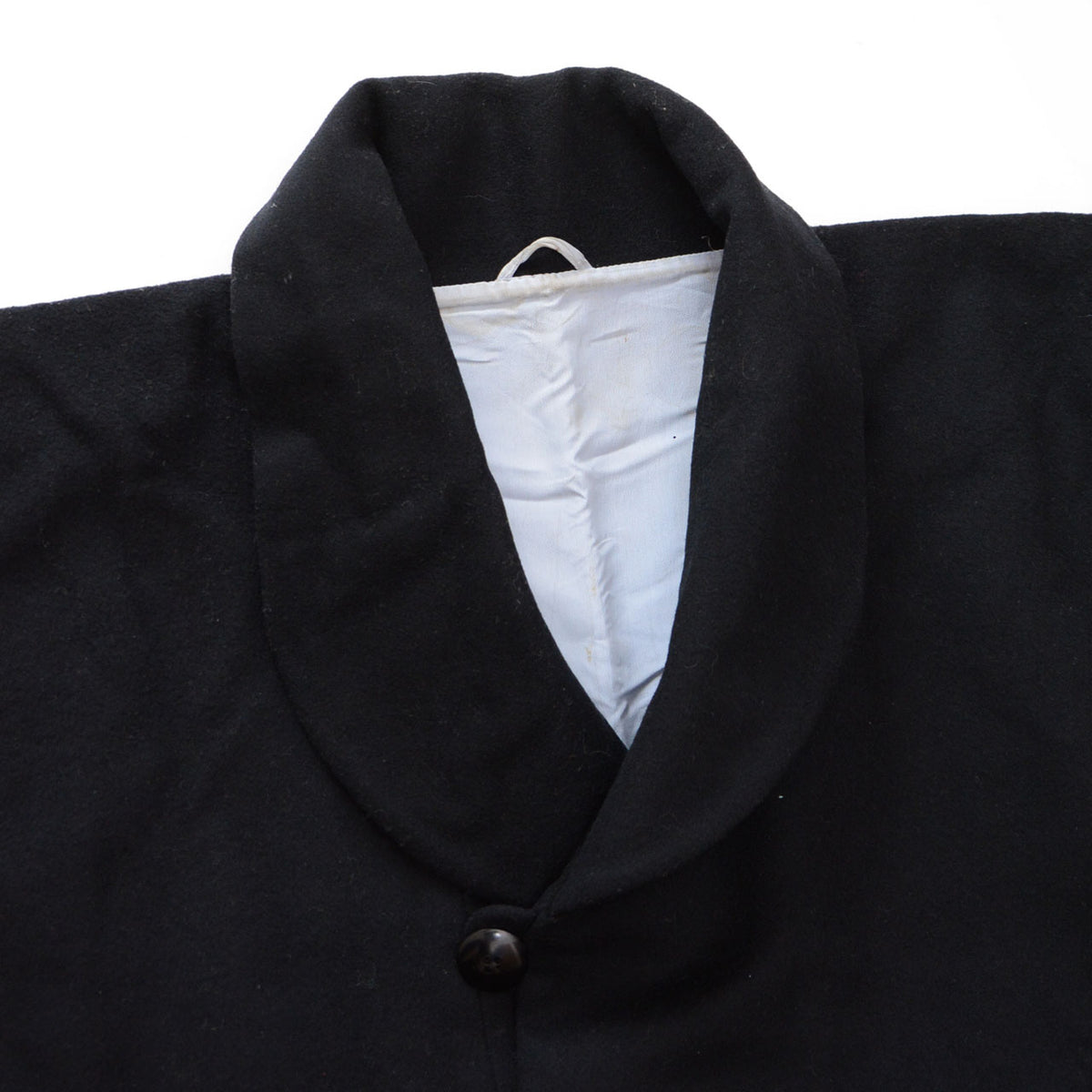 Black wool shawl collar and neck button with pale lining on a Japanese vintage kimono coat