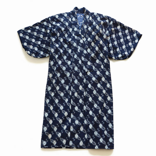 Front view of a Japanese vintage indigo kasuri cotton kimono robe with the collar open, showing the tenugui lining