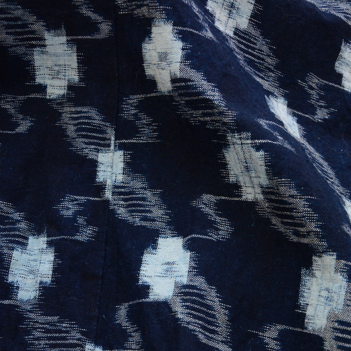 Close-up of the soft drape and woven texture of an indigo kasuri cotton kimono robe