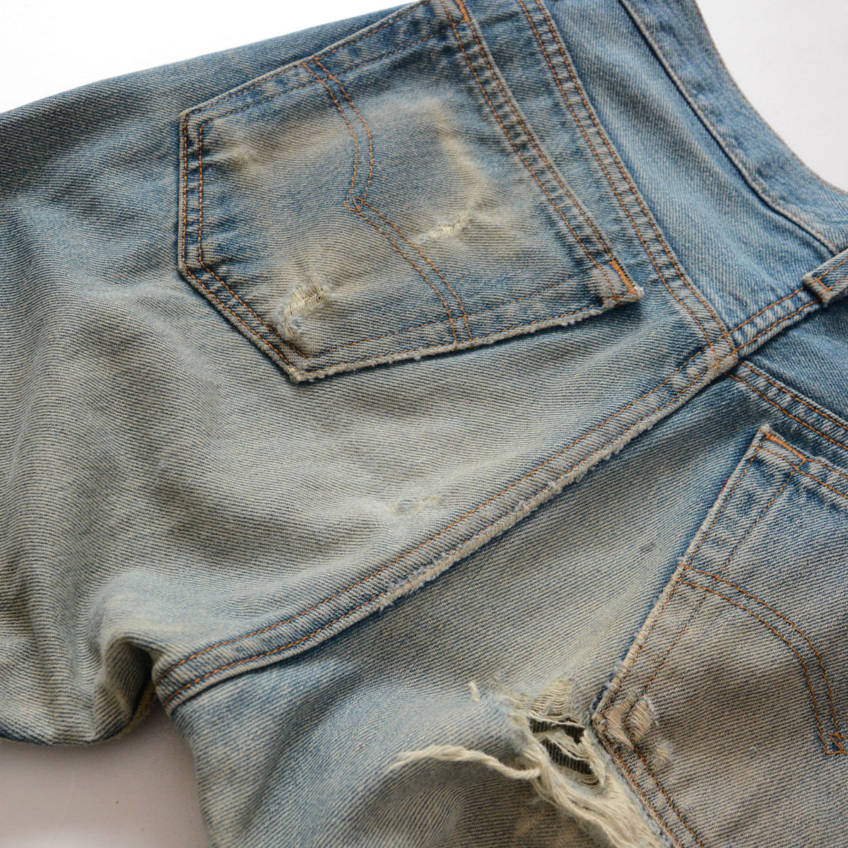 Levi’s 501 faded blue denim with worn rear pockets and arcuate stitching