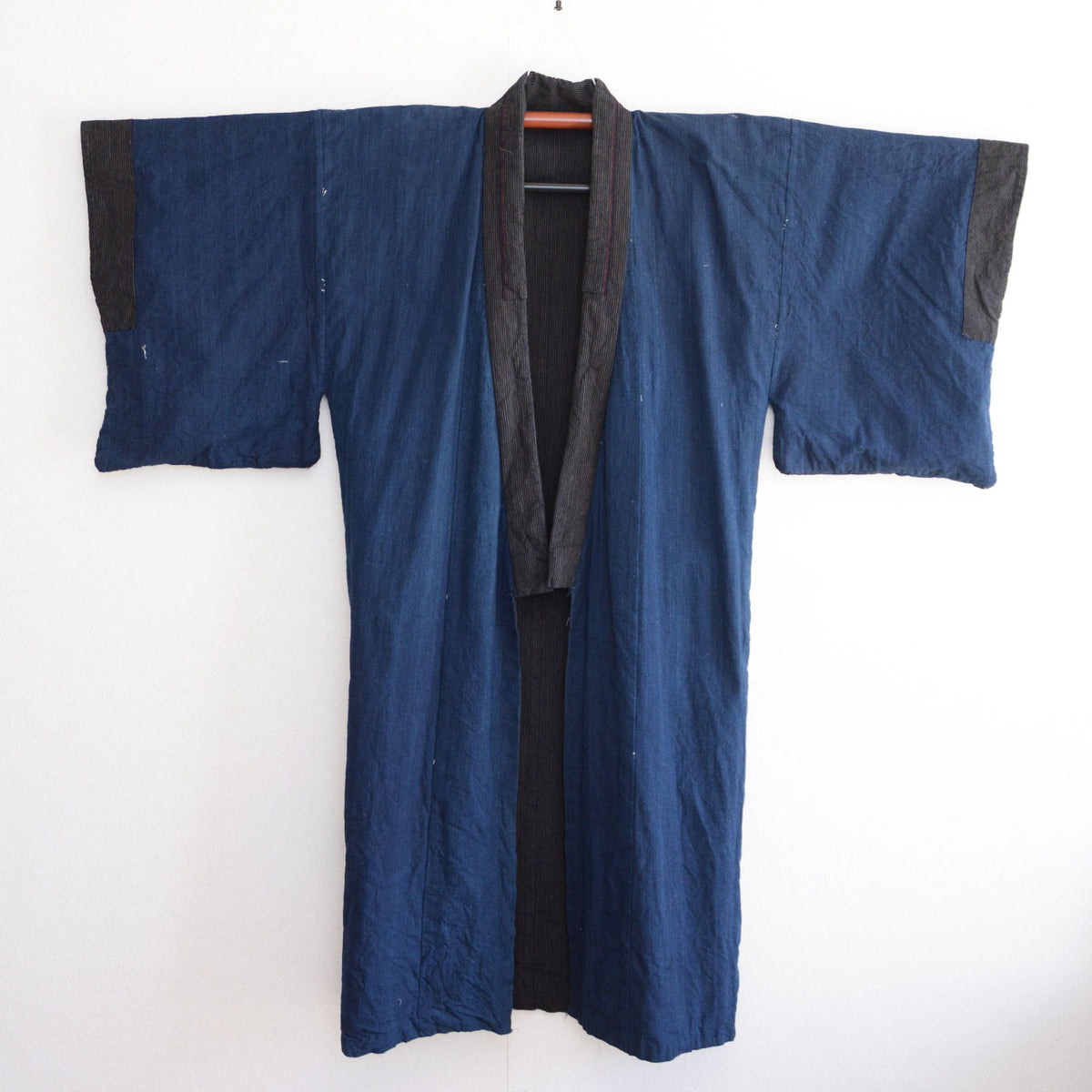 Solid indigo cotton lining and striped collar of a vintage men's kimono robe