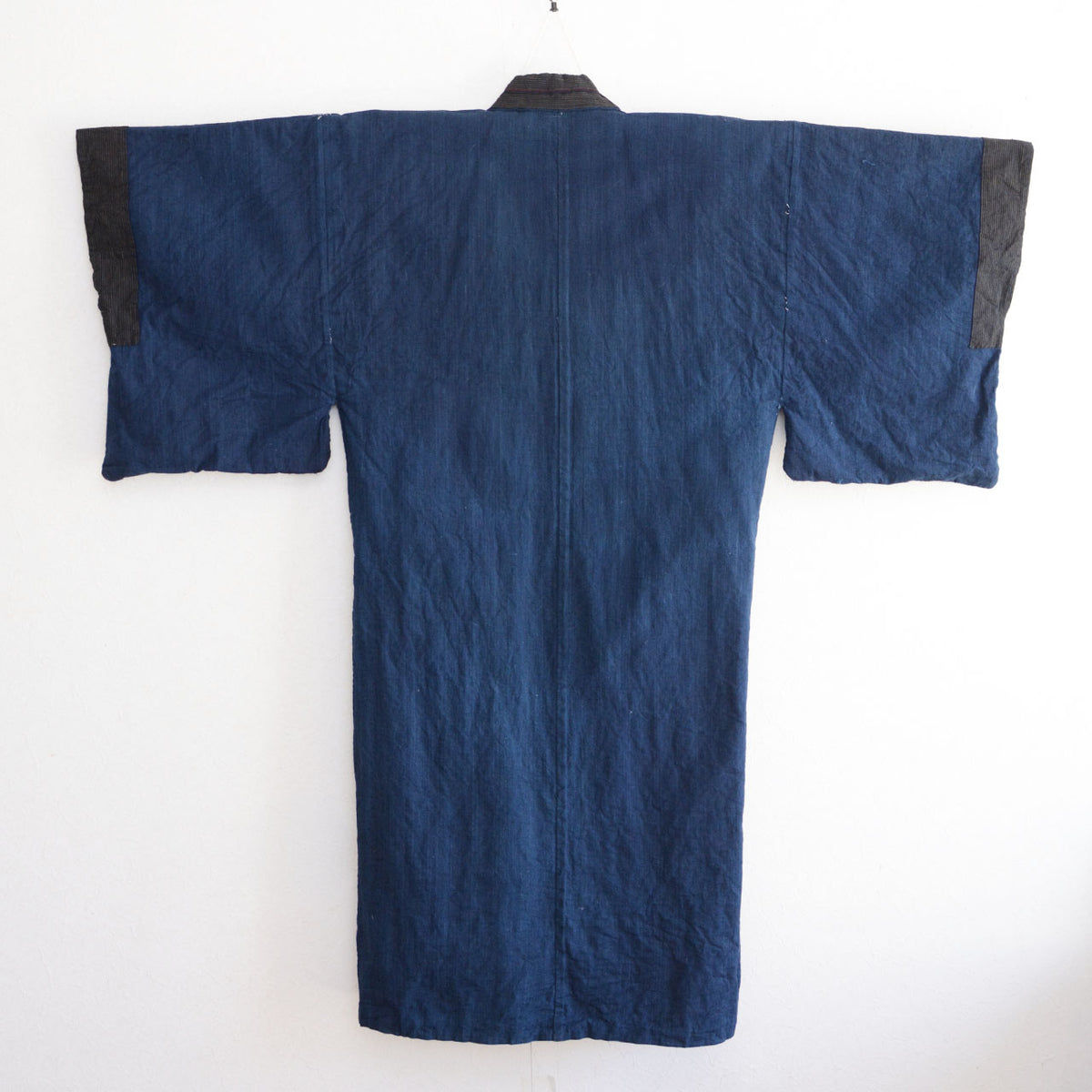 Solid indigo cotton back lining of a vintage men's kimono robe