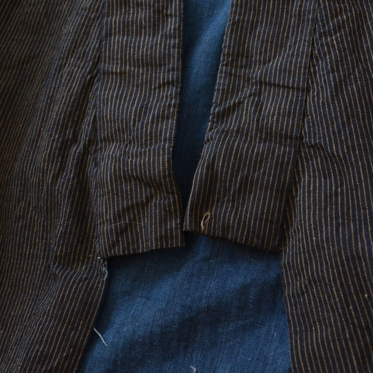 Lower collar with fine striped cotton and solid indigo lining of a men's kimono