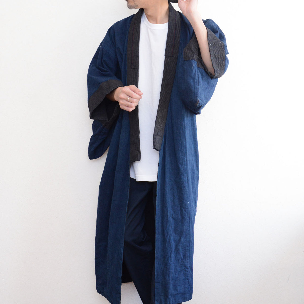 Men's vintage kimono with solid indigo cotton lining and striped collar on a model