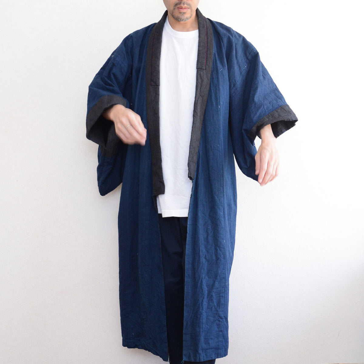 Solid indigo cotton men's kimono robe with striped collar and cuffs on a model