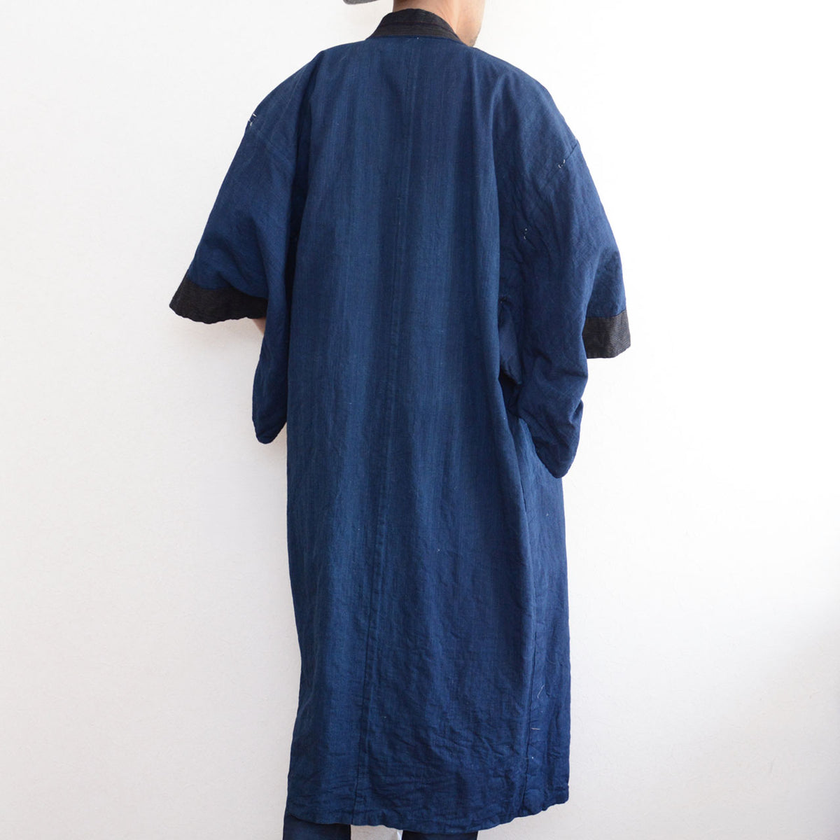 Solid indigo cotton back of a vintage men's kimono robe on a model