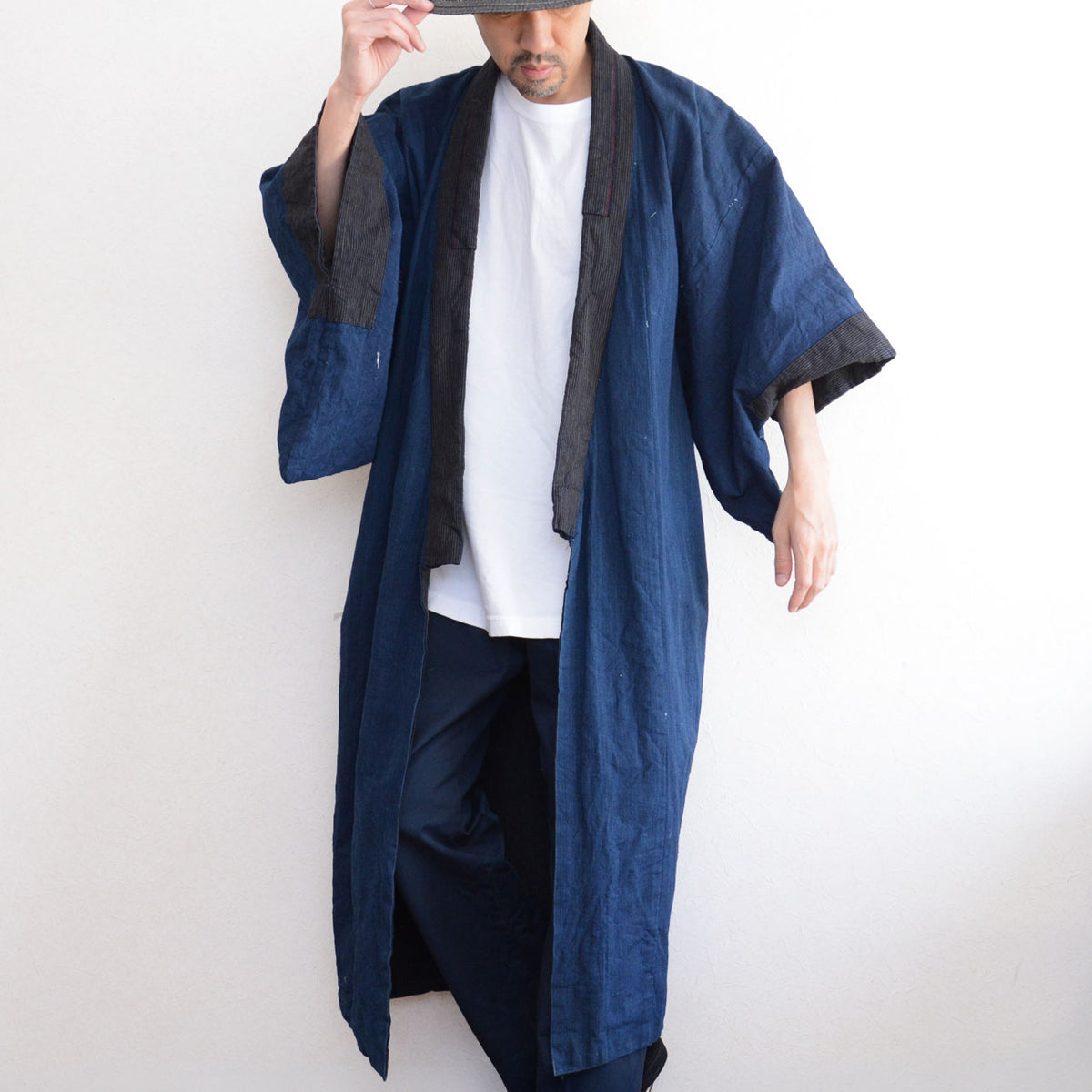Indigo cotton men's kimono robe with striped collar and cuffs on a model