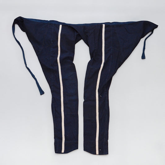 Indigo cotton momohiki laid flat, showing natural-colored stripe detail on both legs