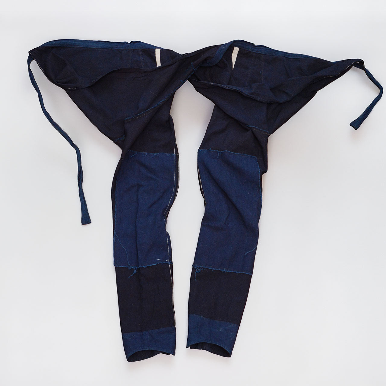 Reverse side of the indigo cotton momohiki laid flat, showing the full construction