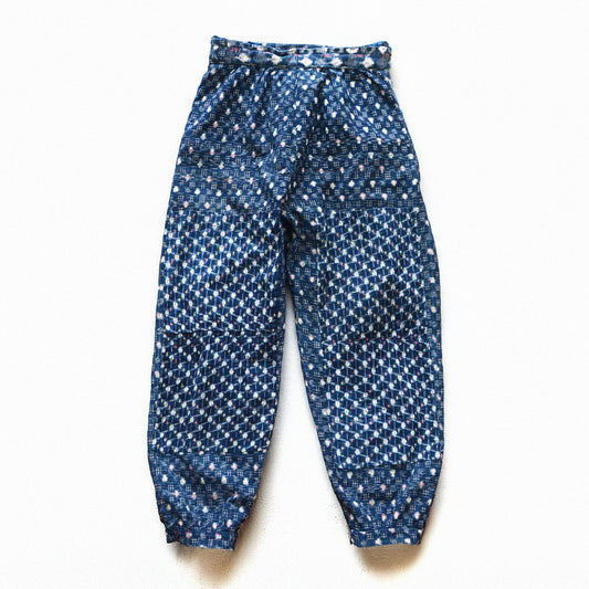 Indigo kasuri cotton mompe pants, front, crazy patchwork of multiple kasuri fabrics, white and multicolor ikat motifs on deep navy ground, mid-Showa vintage Japan