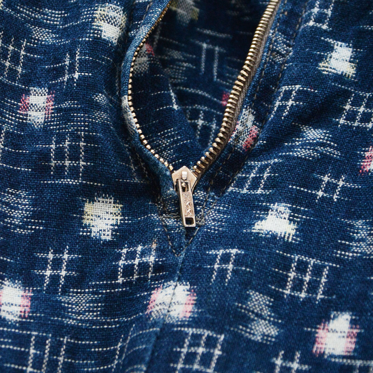 NKK brass side zipper detail on indigo kasuri cotton mompe, mid-Showa vintage Japan