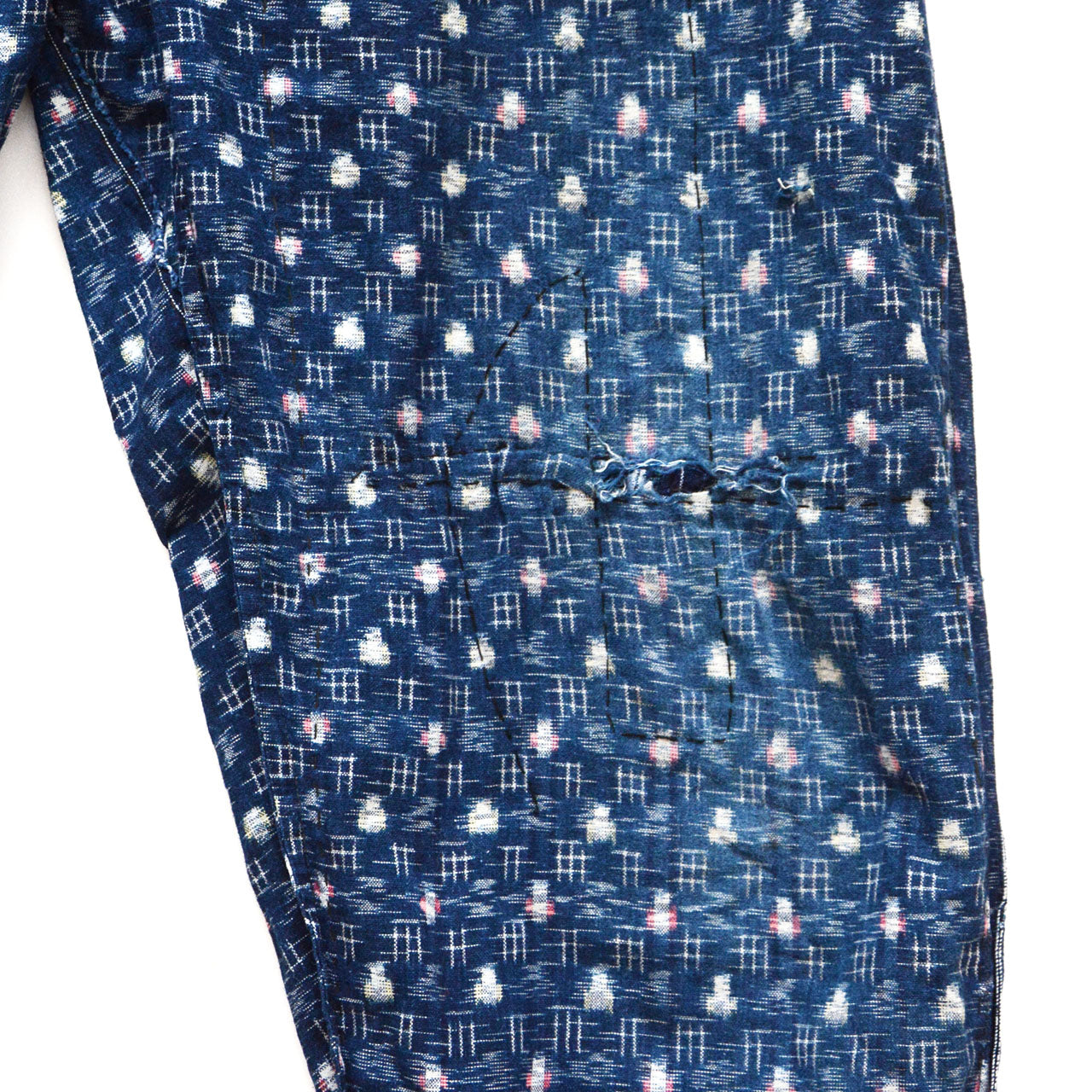 Interior hand-stitching on indigo kasuri mompe, artisan hand-sewn stitches visible on reverse side, mid-Showa vintage Japan