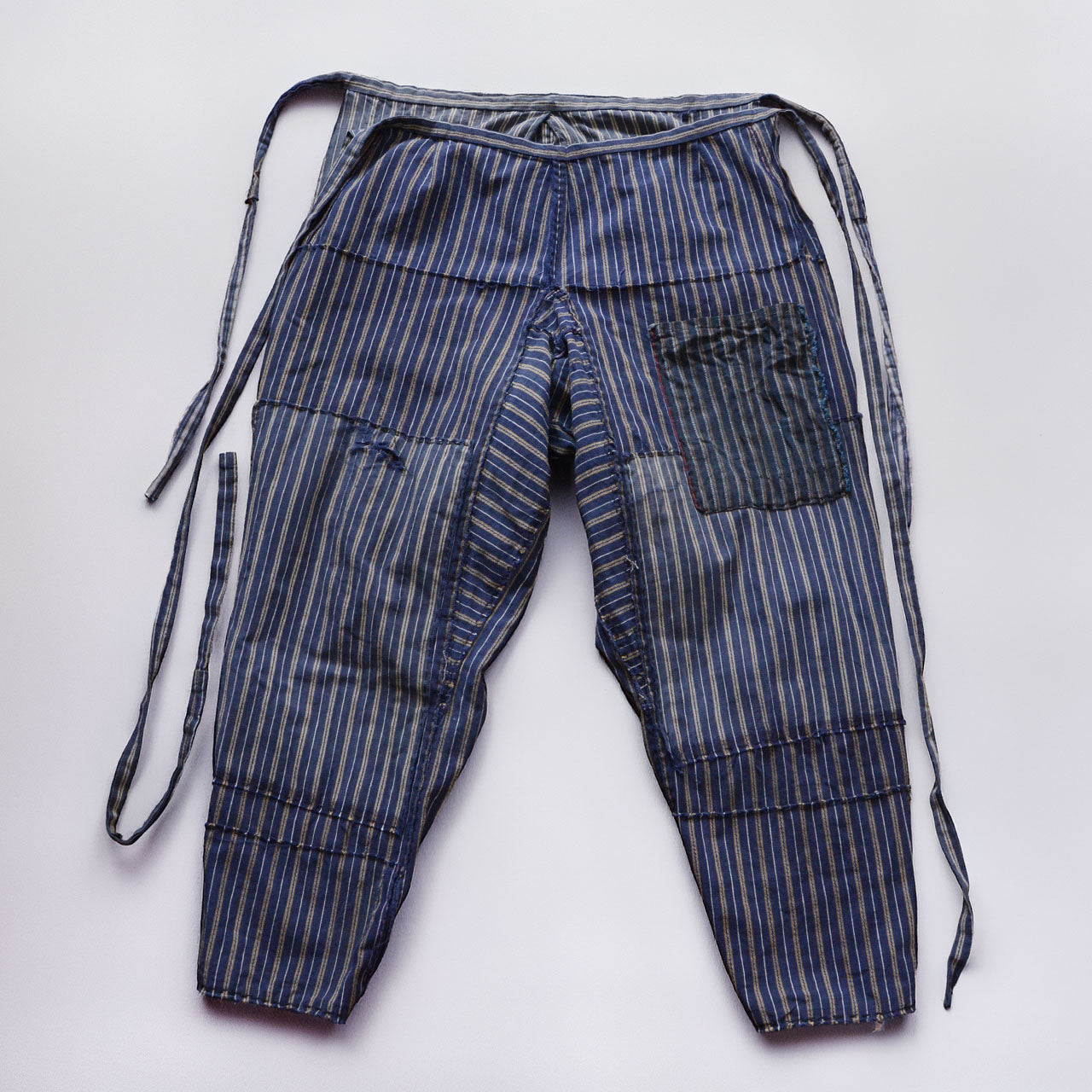Reverse side of stripe cotton monpe pants, full view, blue and white multi-stripe cotton, waist ties, Tohoku Japan vintage, early-to-mid Showa era