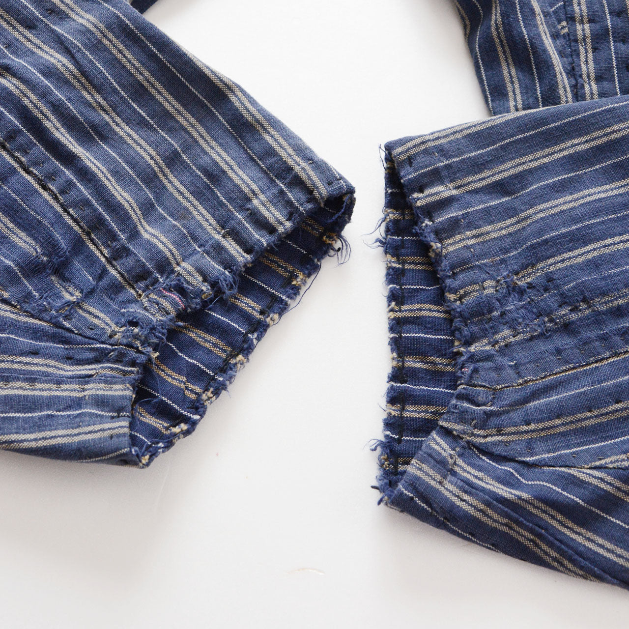 Hem damage detail of stripe cotton monpe pants, naturally distressed frayed edge, blue and white stripe cotton, Tohoku Japan vintage