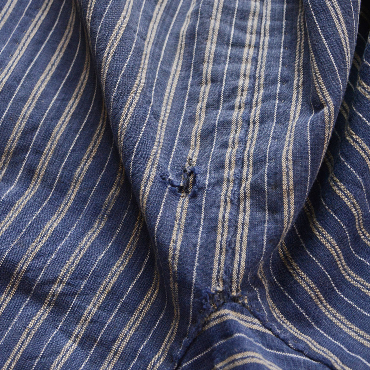 Damage detail on stripe cotton monpe pants, worn and thinning blue stripe cotton, distressed texture, Tohoku Japan vintage