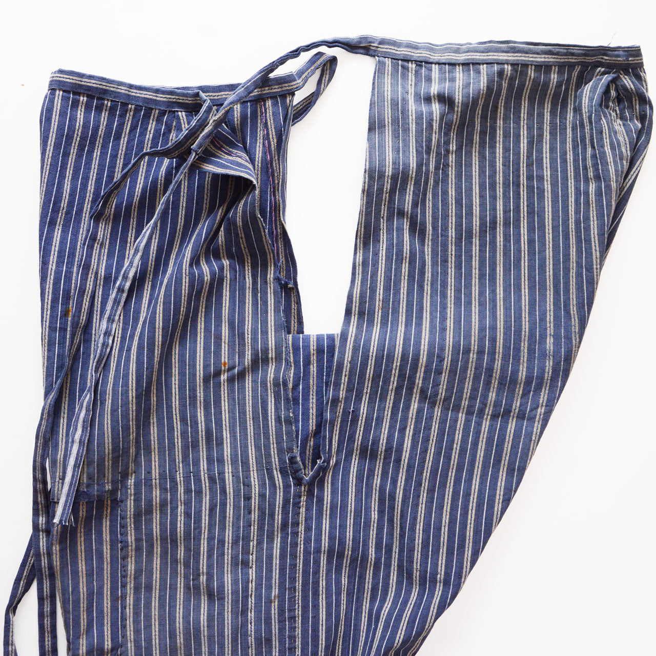 Front and back separated view of stripe cotton monpe pants, slit opening detail, blue and white multi-stripe cotton, Tohoku Japan vintage