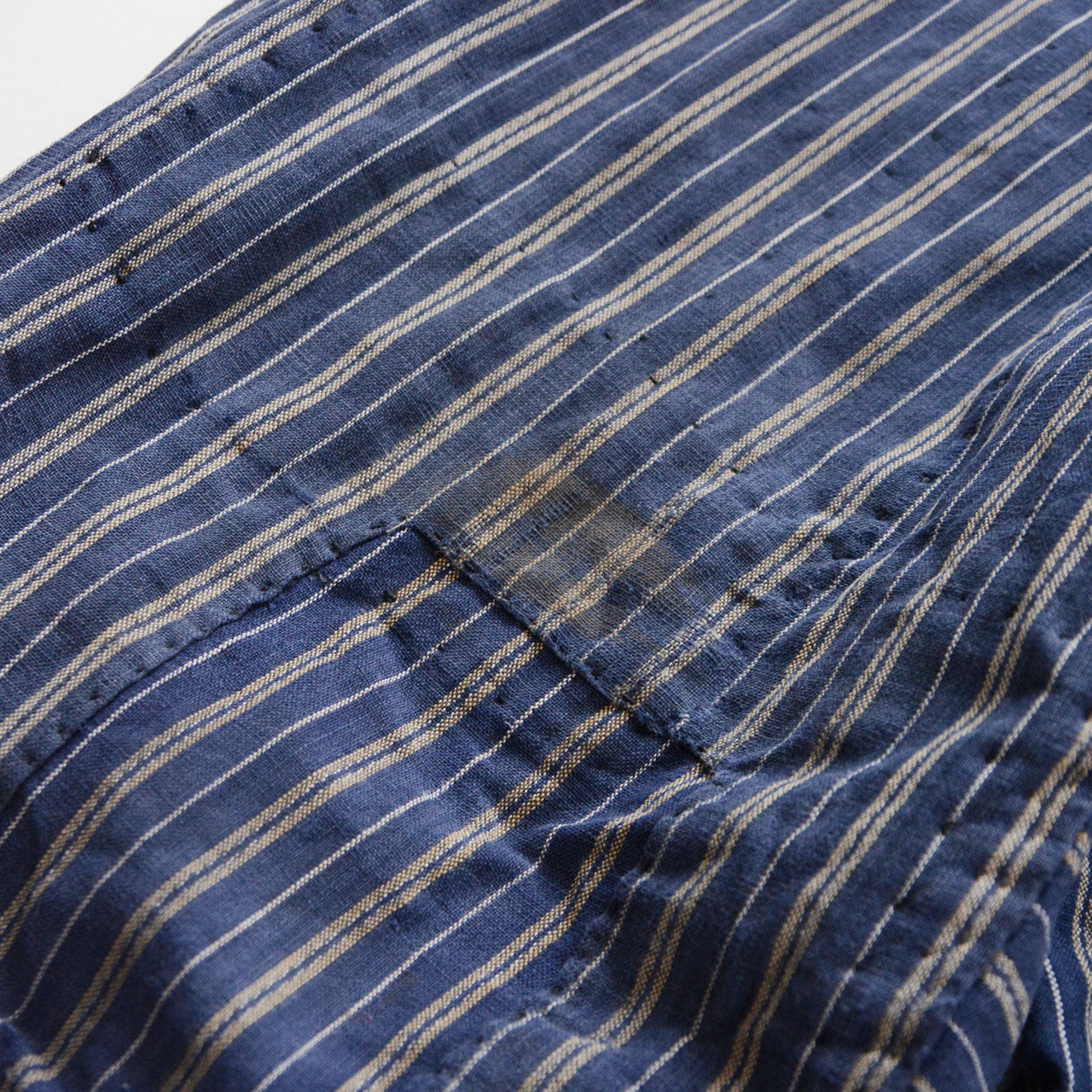 Stain detail on stripe cotton monpe pants, aged discoloration on blue and white stripe cotton, Tohoku Japan vintage