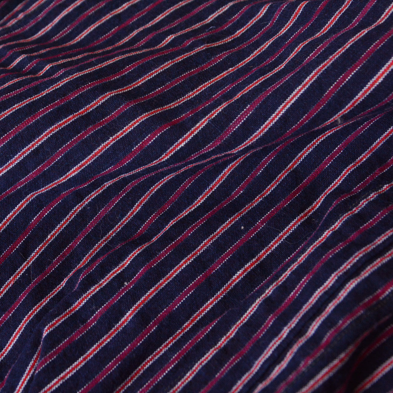 Cotton stripe fabric detail, navy ground with burgundy, red and white multi-color stripe, vintage Japanese monpe, texture and weave visible