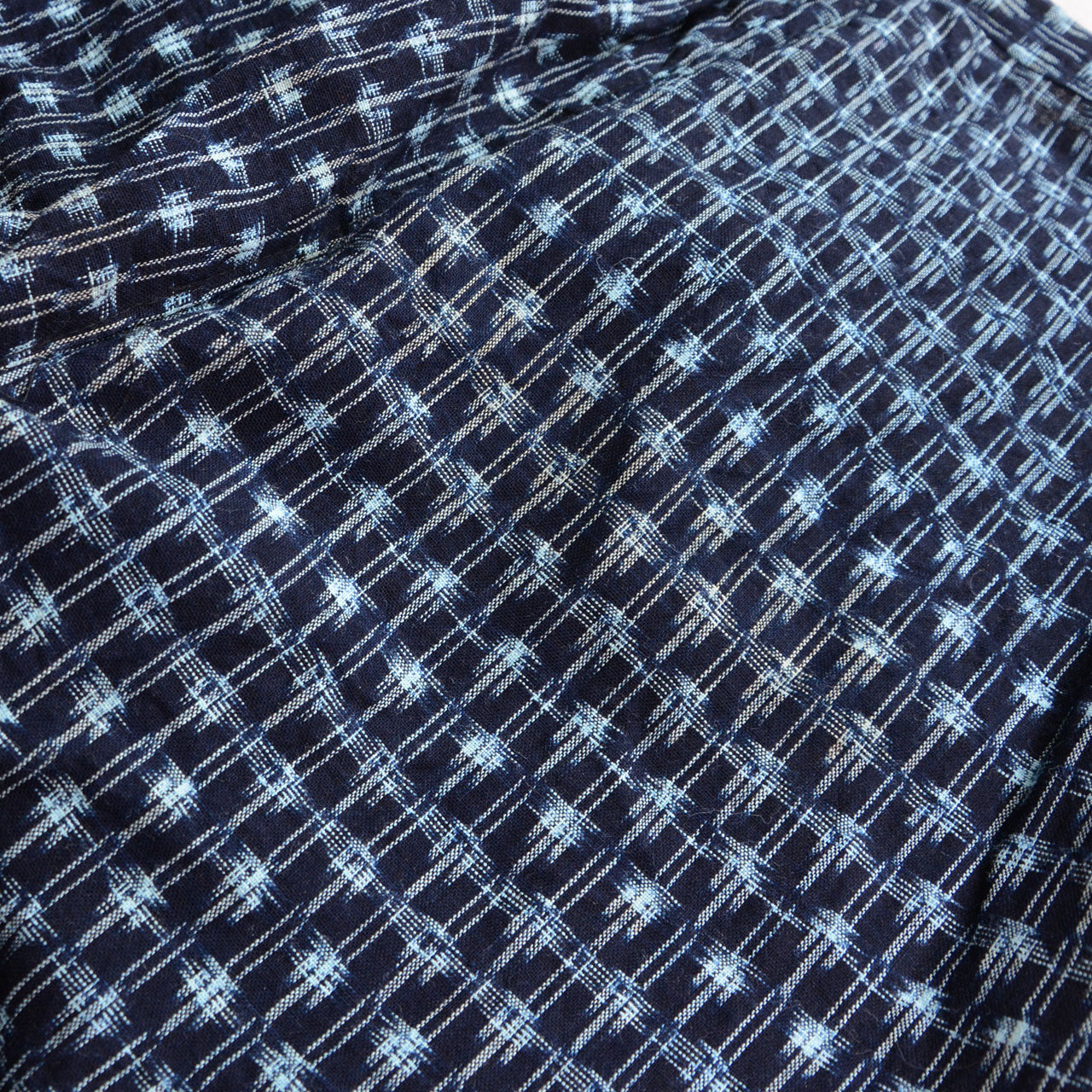 Close-up of indigo Bingo kasuri cotton fabric, ikat grid pattern in white and pale blue on deep navy ground