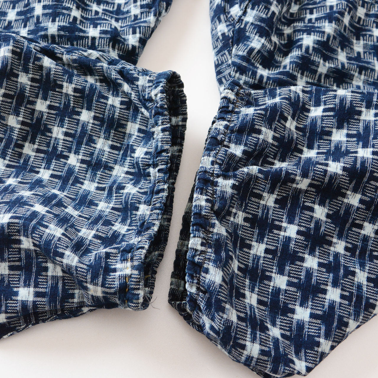 Hem detail of indigo kasuri monpe pants, navy ikat check cotton, Japan vintage