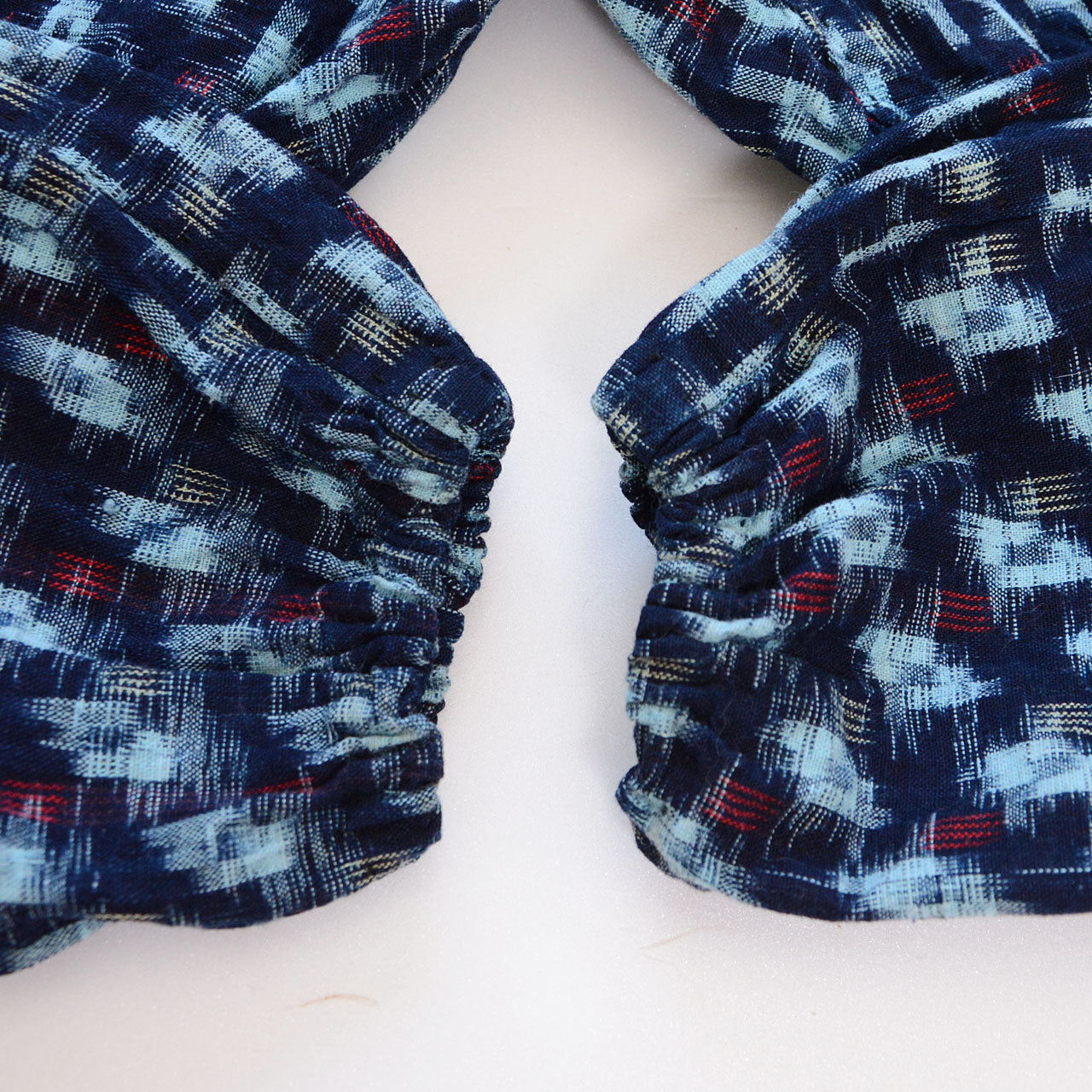 Elastic hem detail of indigo kasuri cotton monpe pants, gathered ankle cuff, navy ikat pattern, Mid-Showa era Japan vintage
