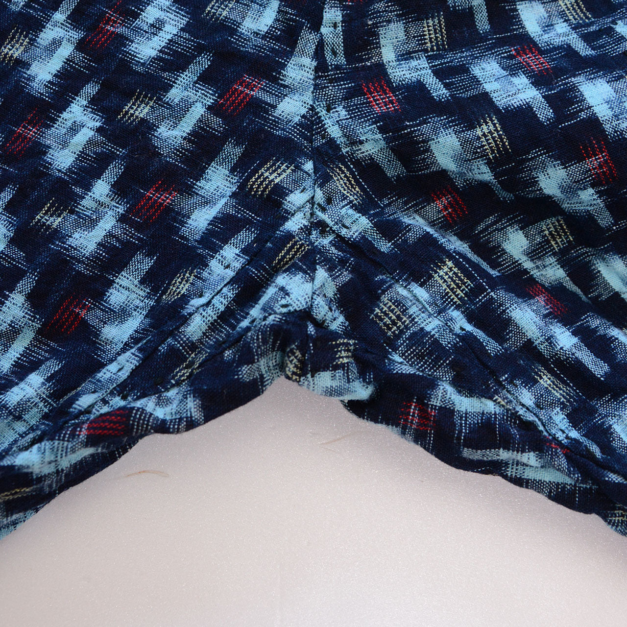 Crotch gusset detail of indigo kasuri cotton monpe pants, diamond-shaped reinforcement panel, navy ikat cotton, Mid-Showa era Japan vintage