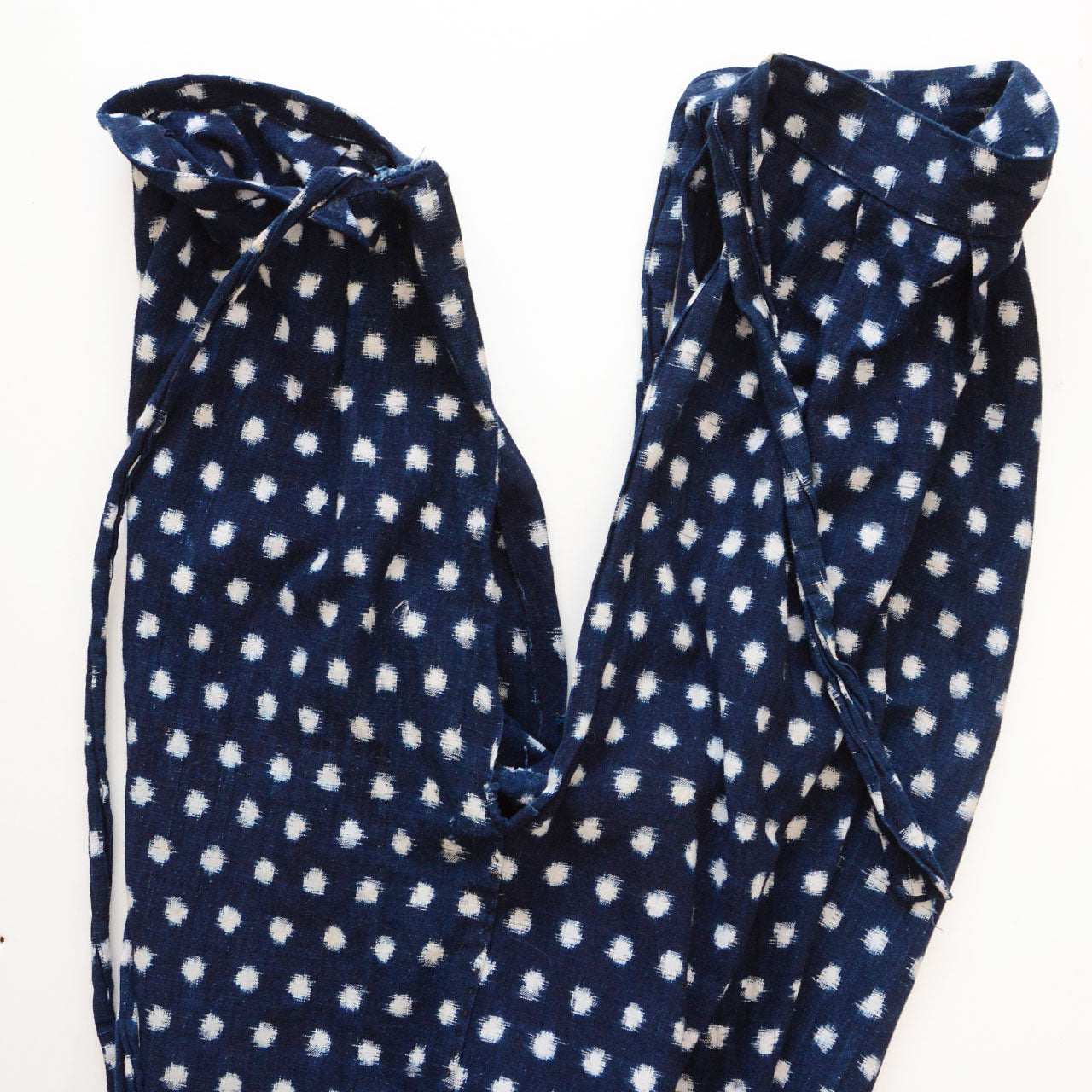 Front and back panels separated showing side slits, indigo snow pattern (Yukinko) kasuri cotton monpe, early Showa era Japan vintage