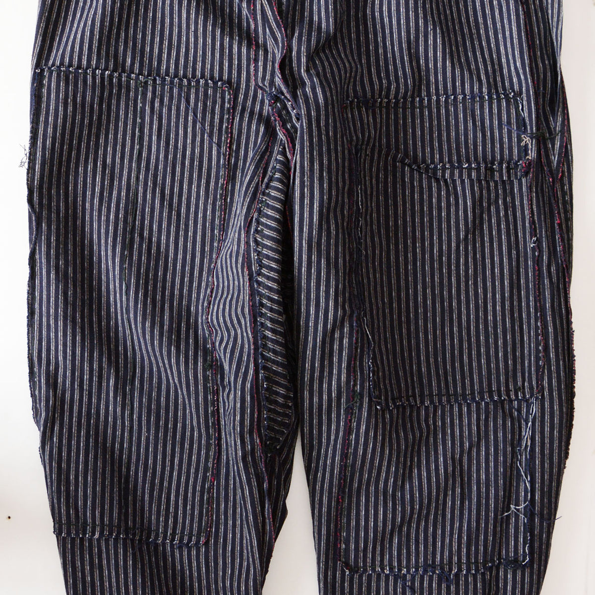 Internal double-knee reinforcement in striped cotton monpe pants
