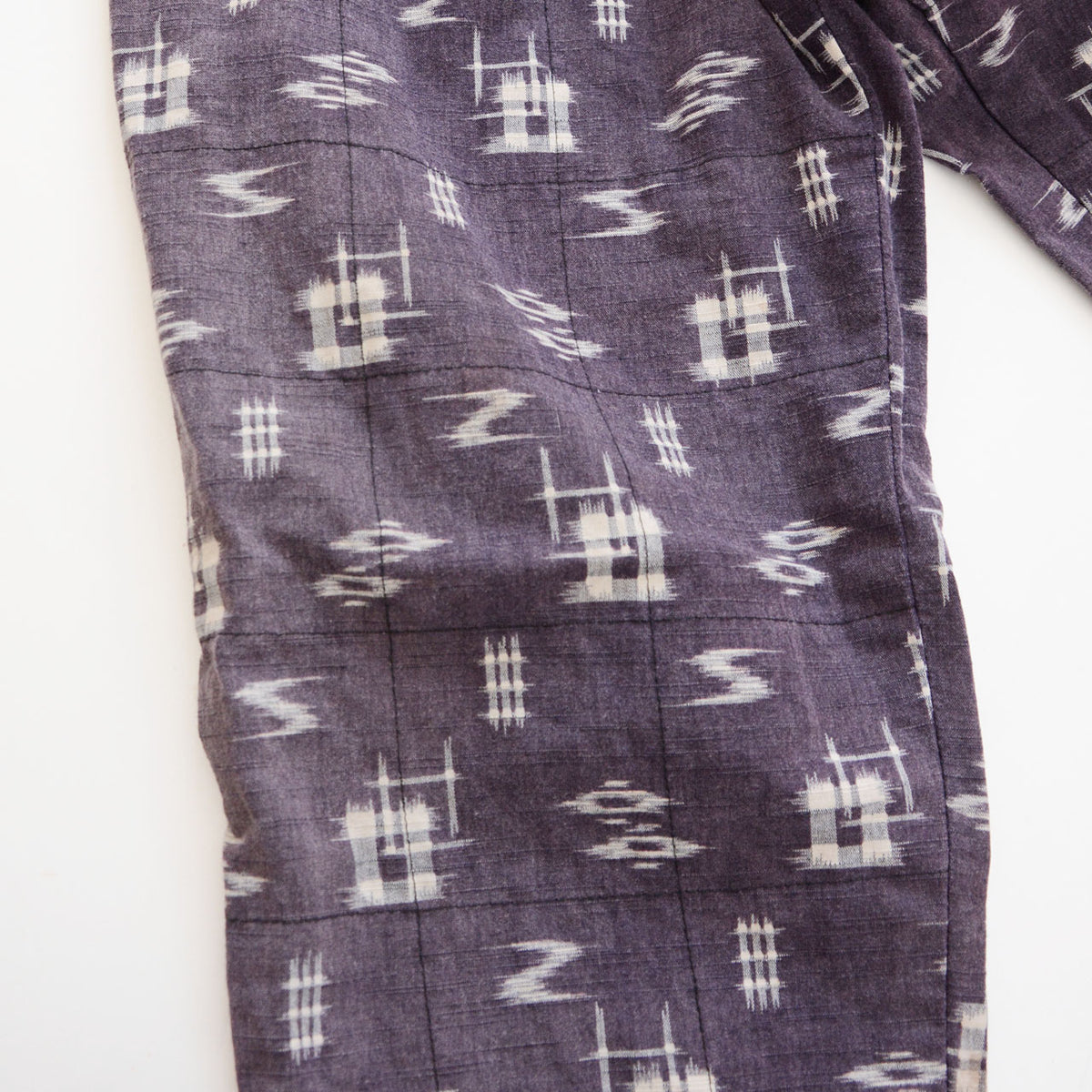 Cotton kasuri fabric and grid-pattern reinforcement stitching on Showa-era Japanese vintage monpe pants