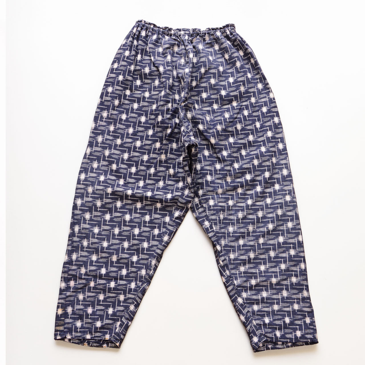 Vintage kasuri monpe pants, back view, navy cotton with white geometric ikat pattern, elastic waist, mid-Showa era Japan