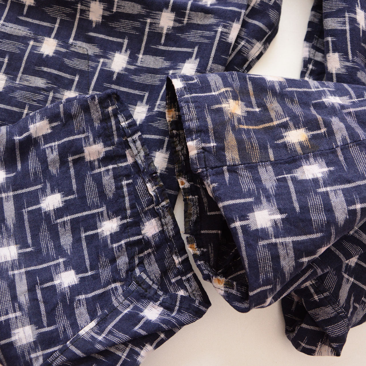Hem of vintage kasuri monpe pants, navy cotton ikat weave, Showa era workwear detail