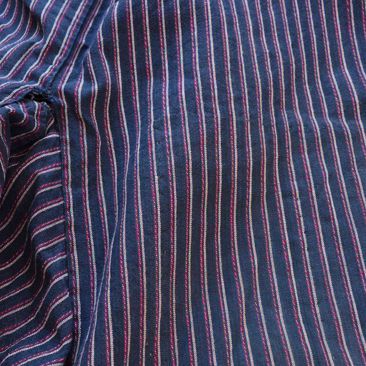 Close-up of striped cotton fabric surface, vintage Japanese monpe, showing natural texture and age