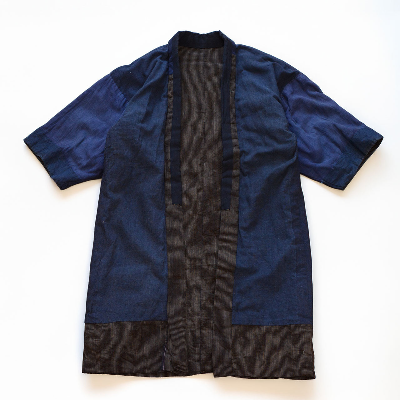 Boro noragi jacket, indigo-dyed cotton body with striped cotton hem, crazy pattern lining visible, pre-WWII Japan vintage, Tohoku