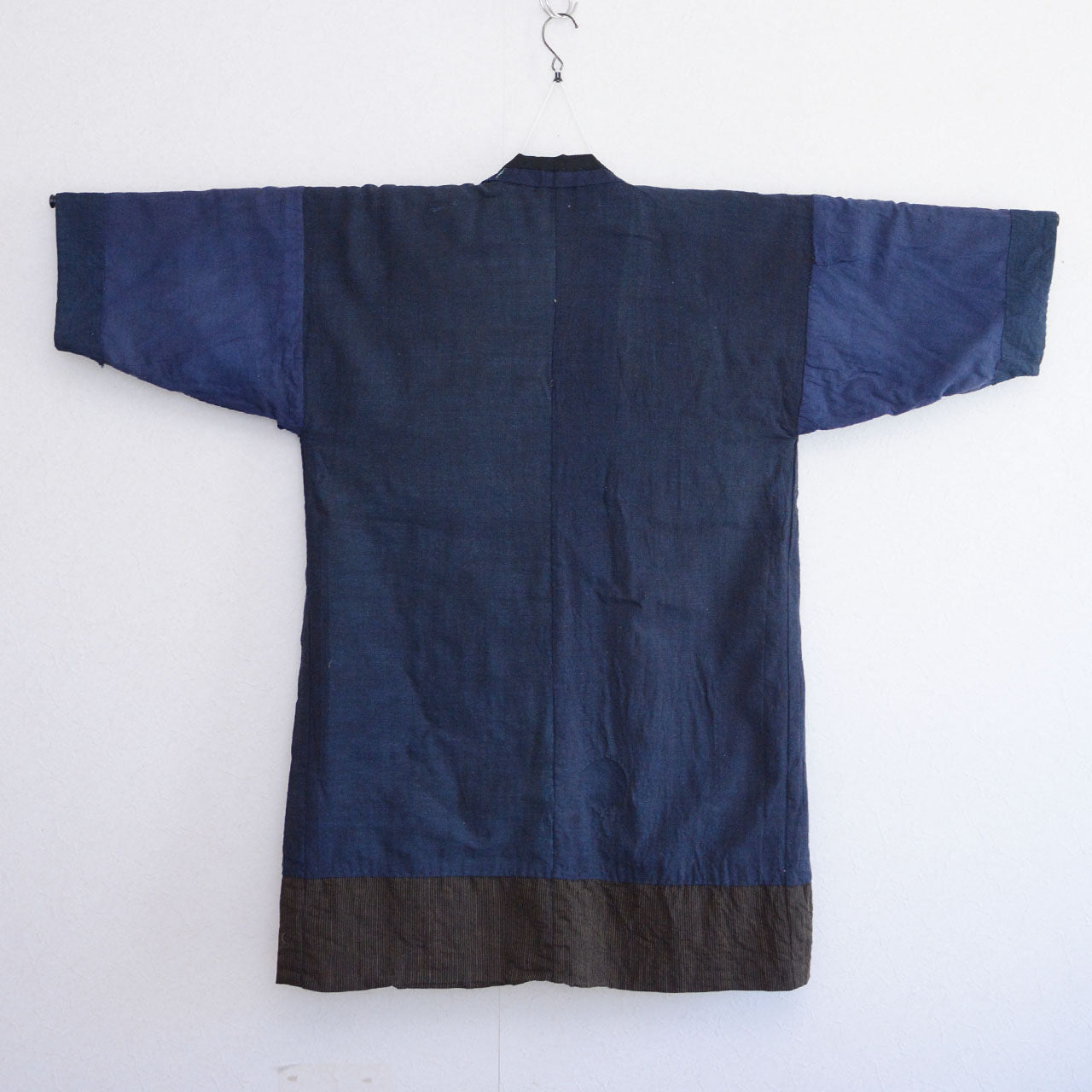 Boro noragi jacket, indigo-dyed cotton outer, back view, striped cotton hem detail, pre-WWII Japan vintage, Tohoku