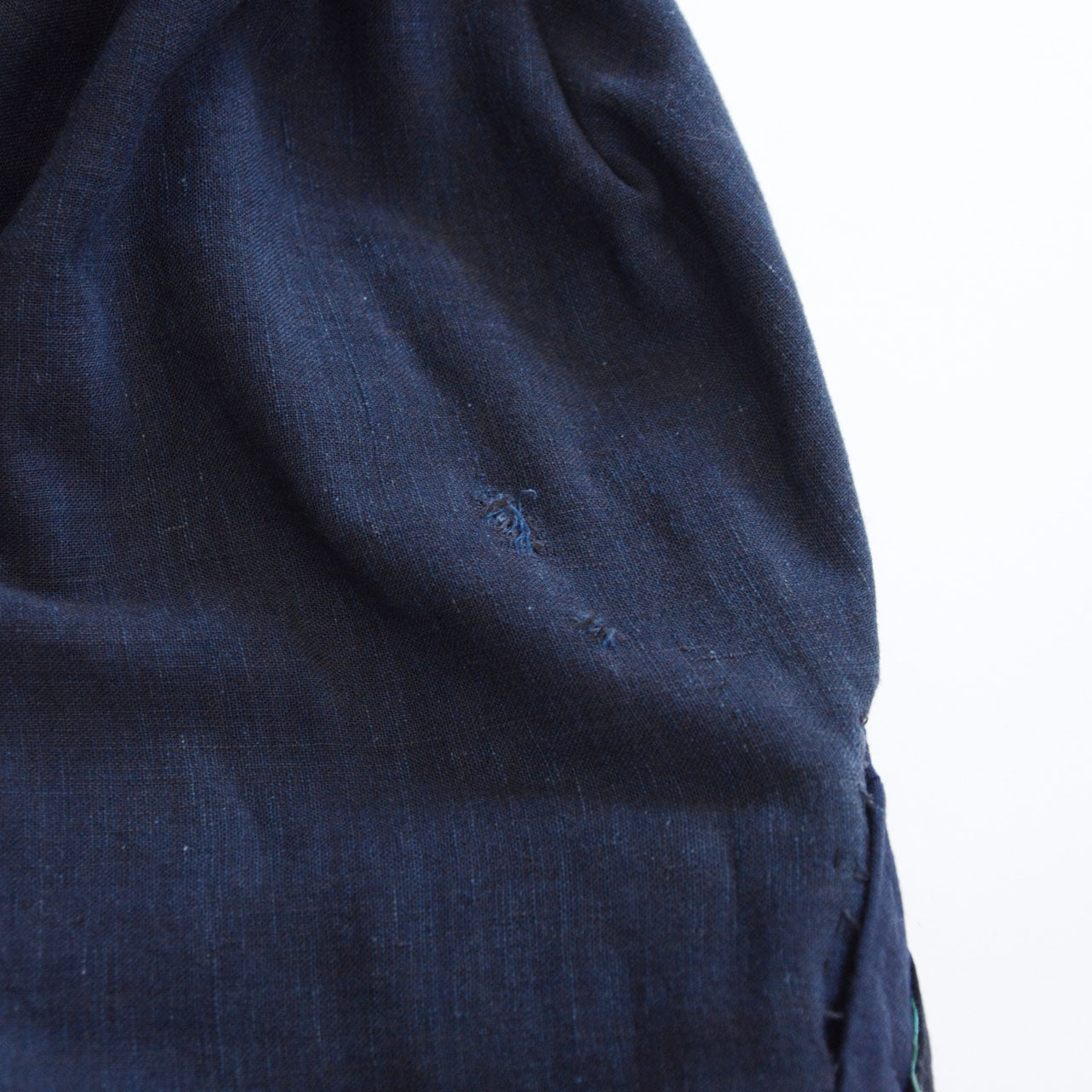 Boro noragi jacket, indigo-dyed cotton lining, damage detail near collar, aged cotton with visible wear, pre-WWII Japan vintage, Tohoku