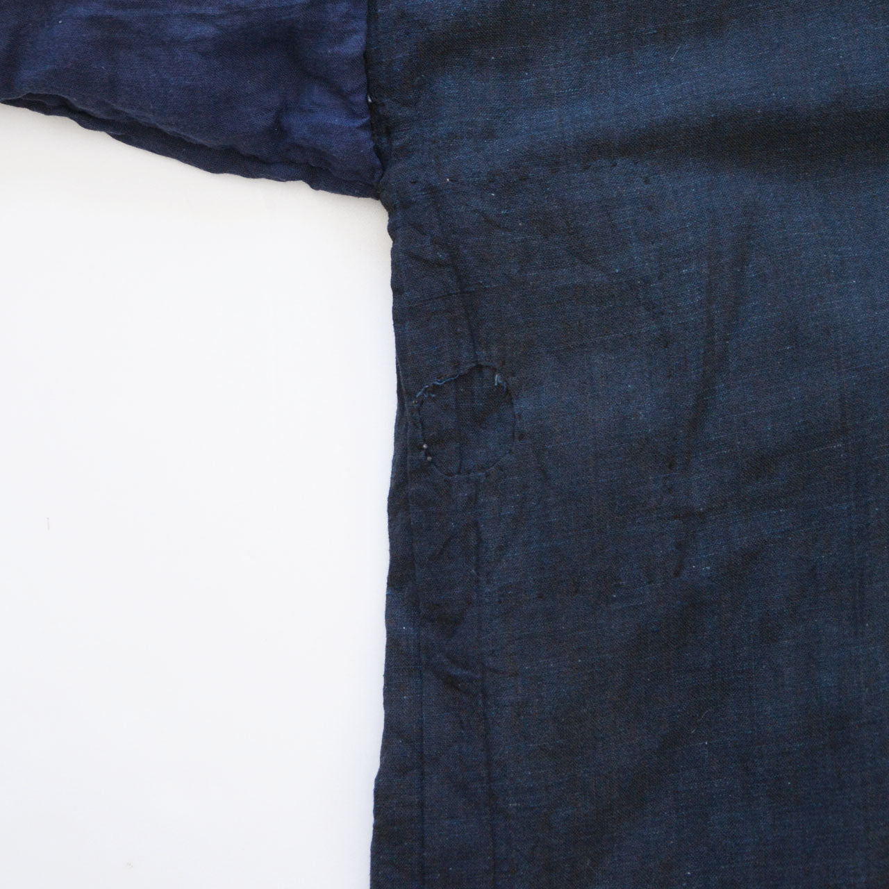 Boro noragi jacket, repair patch near side seam, hand-stitched boro mending on aged cotton, pre-WWII Japan vintage, Tohoku