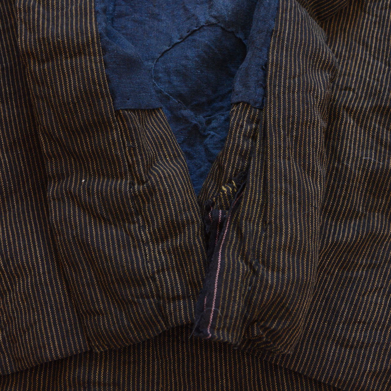 Boro noragi jacket, damage detail at lower collar, aged cotton with visible wear, pre-WWII Japan vintage, Tohoku