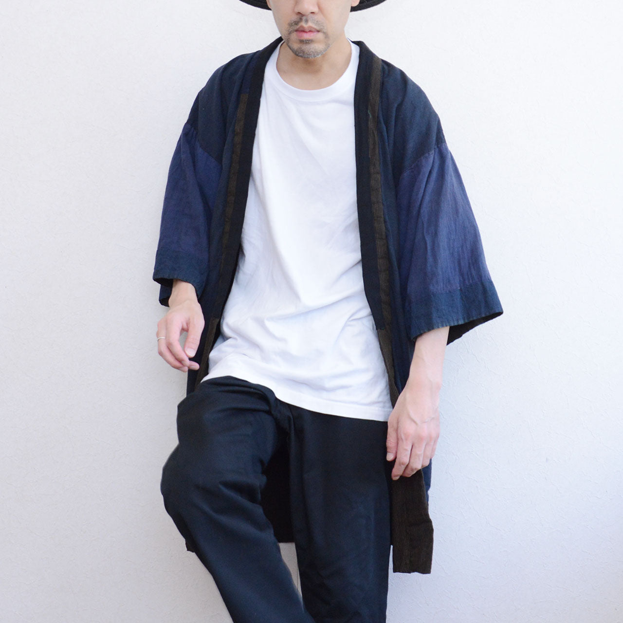 Boro noragi jacket, indigo-dyed cotton outer with striped crazy pattern lining, open front full length, worn over white tee and dark trousers, Japan vintage styling, pre-WWII Tohoku