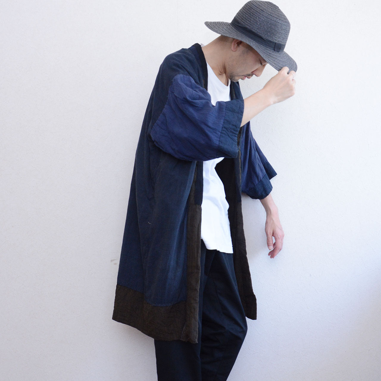 Boro noragi jacket, indigo-dyed cotton outer with striped crazy pattern lining, side view full length, worn over white tee and dark trousers, Japan vintage styling, pre-WWII Tohoku